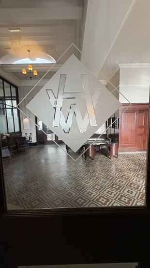 H & W Company logo on old glass door